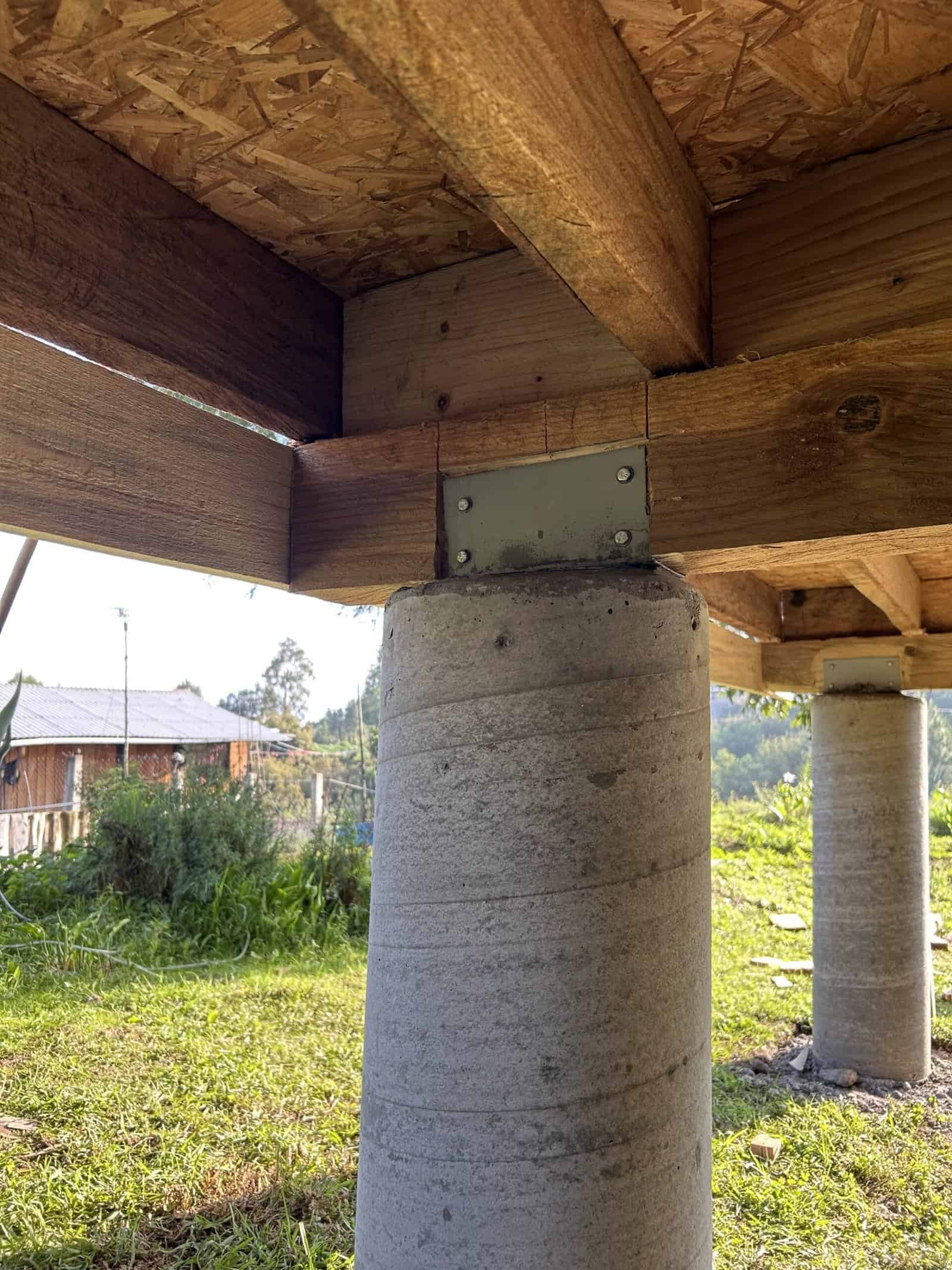 Foundation construction with wooden beams and concrete pillars for building stability.